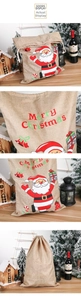 Macro detail of burlap Christmas gift bag with Santa Claus print and drawstring closure