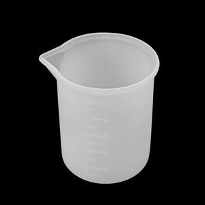 Close-up of a 100ml silicone measuring cup with precise markings for resin DIY