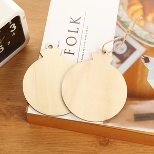 Detail of two natural wooden circle ornaments with twine strings for DIY holiday decor