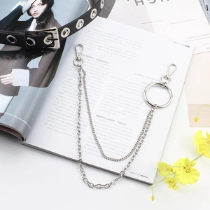 Silver double layer punk chain with metal rings and lobster clasps on a magazine