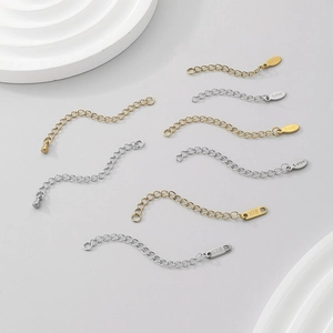 Macro shot of 18K gold and silver stainless steel extension chains with S.steel stamps