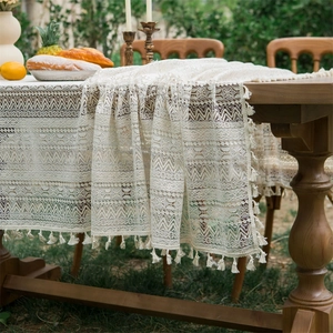 Beige lace tablecloth with vintage crochet texture and tassels for outdoor wedding decor