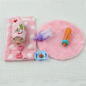 Miniature silicone pig toy set with pink polka dot wrap, plush mat and nursing bottles