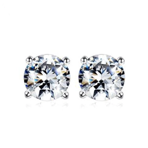 Macro shot of silver round zircon earrings with classic four-prong setting and clear stones