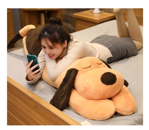 Soft plush puppy pillow shown in a cozy bedroom setting for kids and adults