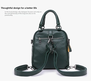 Detail view of dark green pebbled leather backpack with sturdy metal back zipper pocket