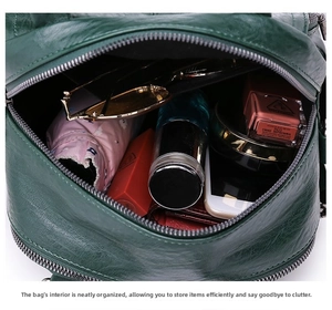Interior view of dark green leather backpack showing spacious storage for daily essentials