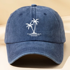 Close-up of white palm tree and wave embroidery on blue washed cotton baseball cap