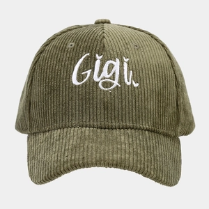 Close-up of green corduroy baseball cap featuring detailed white Gigi embroidery text