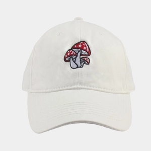Close-up of high-quality white baseball cap featuring three red mushroom embroideries