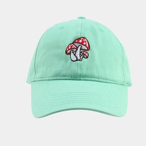 Detailed close-up of mint green baseball cap featuring delicate red mushroom embroidery