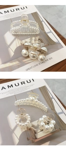 Close-up of pearl-embellished transparent hair claws in various geometric shapes