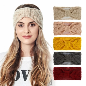 Winter cable knit headband for women with fleece lining and twisted bow design