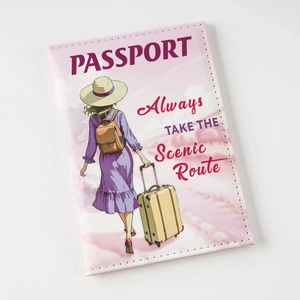 Pink faux leather passport cover with UV print illustration and travel quote on white background