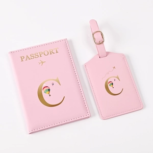Detailed close-up of pink PU leather passport cover and luggage tag with gold hot stamping