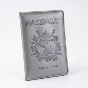 Close-up of silver PU leather passport cover with world map and PASSPORT embossed design