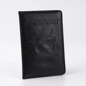 Detailed close-up of the embossed world map and travel text on black PU leather passport cover
