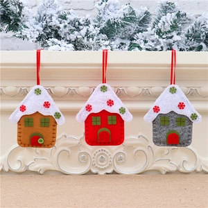 Detailed view of handmade felt house ornaments in red, brown and grey for Christmas trees