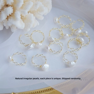 Close-up of handmade natural baroque pearl rings with 14k gold plated wire wrap