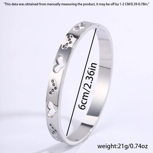 Detailed side view of silver heart cutout steel bangle showing 6cm diameter and 21g weight