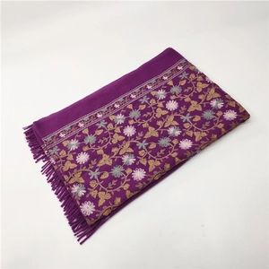 Detailed embroidery floral patterns and fringe tassels on a purple cashmere-like shawl