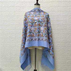 Light blue embroidered faux cashmere shawl with floral vine patterns and fringe edges