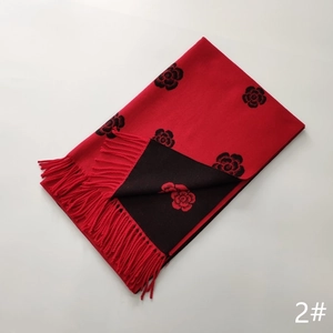 Close-up of red and black cashmere shawl featuring rose patterns and tassel details