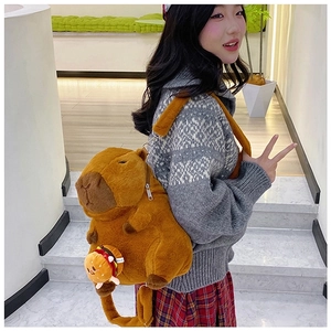Cute Capybara plush backpack with burger pendant shown on model back for size scale