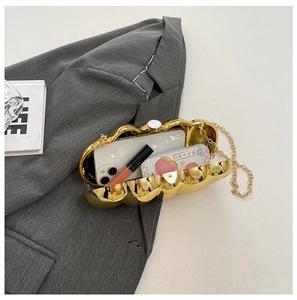 Golden acrylic clutch bag with marble waves showing phone and lipstick interior capacity