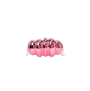 Detailed macro view of metallic pink wave texture acrylic clutch with gold chain