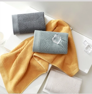 Detailed view of geometric waffle weave texture on soft thick cotton bathroom towels