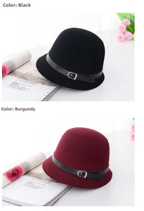 Close-up of wool fedora hats in black and wine red with leather buckle detail