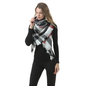 Detail shot of the soft cashmere-feel fabric and classic checkered pattern with fringe