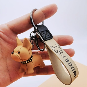 French Bulldog keychain featuring a tan pup pendant and beige leather wrist strap