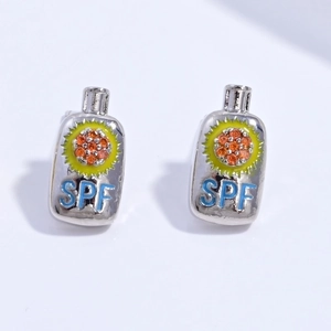 Detail view of sunscreen bottle studs with yellow sun motif and blue SPF lettering