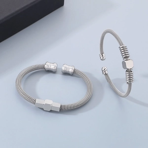 Macro view of silver cable wire bracelets with a textured finish and hexagonal cubes