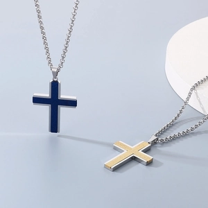 Detailed view of blue and gold cross pendants with matte finish and silver frames