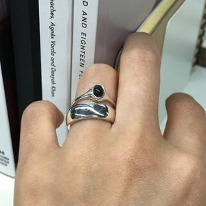 Close-up of 925 sterling silver black agate ring set on hand with minimalist design