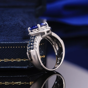 Macro side view of elegant S925 silver ring featuring an oval faux sapphire and rhinestones