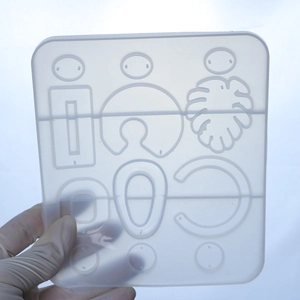 Detailed view of silicone resin earring mold featuring monstera leaf and geometric shapes