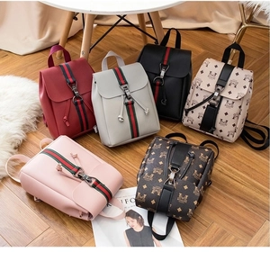 Detailed display of assorted mini PU leather backpacks with striped straps and prints