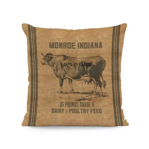 Detailed view of linen cushion cover featuring vintage cow print and farm feed typography