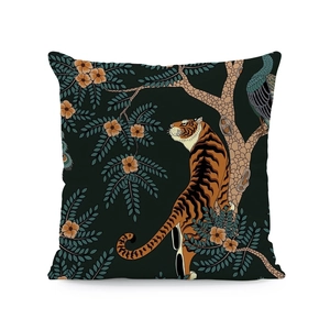 Detail of linen cushion cover featuring artistic tiger, peacock and floral patterns
