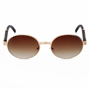Detalle de gafas de sol ovales vintage con montura dorada y lentes degradadas
