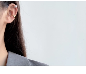 Close-up of minimalist S925 silver and gold twisted ear cuffs on female model