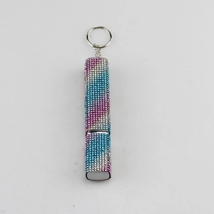 Detail of refillable perfume bottle keychain with rainbow gradient rhinestones