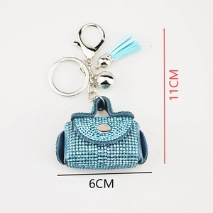 Close-up of blue rhinestone mini bag keychain with light blue tassel and dimensions
