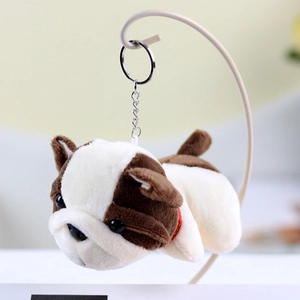 Close-up of brown and white bulldog plush keychain with a soft red collar and metal ring