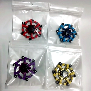 Four colorful transformable chain fidget spinners in red, blue, purple and yellow colors