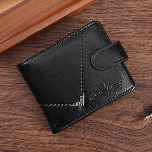 Short leather wallet for men on dark wood background with zipper and snap button closure